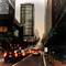 Heavy evening traffic with red brake lights on steep San Francisco street, tall buildings on both sides, cars backed up in multiple lanes