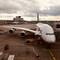 Lufthansa Airbus A380 aircraft parked at gate with ground equipment and terminal buildings at Frankfurt Airport, Germany